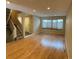 Bright living room featuring wood floors, a large window, and staircase access to the upper level at 935 N Pennsylvania St # 3, Denver, CO 80203