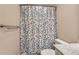 Clean bathroom with shower/tub combo and patterned shower curtain at 11733 Elk Head Range Rd, Littleton, CO 80127