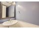 Small bathroom with white sink, vanity, and light purple walls at 11733 Elk Head Range Rd, Littleton, CO 80127