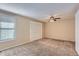 Carpeted bedroom with ceiling fan and double door closet at 11733 Elk Head Range Rd, Littleton, CO 80127