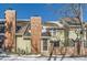 Rear exterior of townhome with brick chimney and snow on the ground at 11733 Elk Head Range Rd, Littleton, CO 80127