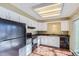 Galley style kitchen with white cabinets, black appliances, and granite countertops at 11733 Elk Head Range Rd, Littleton, CO 80127