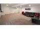 Finished basement with large sectional sofa and red refrigerator at 11860 Sandcastle Ct, Parker, CO 80138