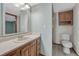 Bathroom featuring a single sink vanity, wood-look cabinets and tiled flooring at 1737 Jules Ct, Highlands Ranch, CO 80126