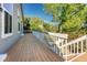 Spacious deck with white railing and wooden floor, offering scenic views of the surrounding greenery at 1737 Jules Ct, Highlands Ranch, CO 80126