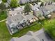 Aerial view of backyard featuring the house, patio, and green grass at 9676 W Chatfield Ave # B, Littleton, CO 80128