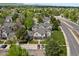 An aerial view displays well-maintained townhomes with street access, parking, and proximity to nearby roadways and green spaces at 9676 W Chatfield Ave # B, Littleton, CO 80128