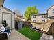 A cozy backyard featuring green grass, a small patio, and fencing at 9676 W Chatfield Ave # B, Littleton, CO 80128