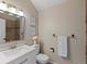 Well-lit bathroom with white vanity, modern mirror, and decorative accents at 9676 W Chatfield Ave # B, Littleton, CO 80128