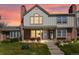 Charming two-story home with a brick facade, complemented by a well-manicured lawn and inviting front porch under an orange sunset at 9676 W Chatfield Ave # B, Littleton, CO 80128