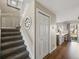 Hallway with stairwell features luxury vinyl plank flooring, closet and kitchen view at 9676 W Chatfield Ave # B, Littleton, CO 80128