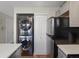Efficient kitchen layout with stainless steel appliances, stacked washer/dryer and storage at 9676 W Chatfield Ave # B, Littleton, CO 80128