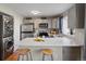 Well-equipped kitchen with stainless steel appliances, white quartz countertops and adjacent laundry at 9676 W Chatfield Ave # B, Littleton, CO 80128