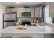 Bright kitchen with stainless steel appliances, white quartz countertop and bar stool seating at 9676 W Chatfield Ave # B, Littleton, CO 80128