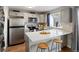 Modern kitchen with stainless steel appliances, white quartz countertop and breakfast bar at 9676 W Chatfield Ave # B, Littleton, CO 80128