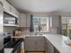 Bright kitchen showcases updated cabinets, countertops, and a window with a view of the outdoors at 9676 W Chatfield Ave # B, Littleton, CO 80128