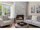 Comfortable living room with a stone fireplace, plush seating, and a view of the outdoors at 9676 W Chatfield Ave # B, Littleton, CO 80128