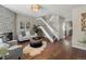Inviting living room boasts a fireplace, hardwood floors, and staircase to the second level at 9676 W Chatfield Ave # B, Littleton, CO 80128