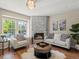 Inviting living room with stone fireplace, hardwood floors, and plenty of natural light at 9676 W Chatfield Ave # B, Littleton, CO 80128