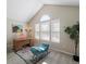 Bright office with a vaulted ceiling, natural light, and desk on a decorative rug at 9676 W Chatfield Ave # B, Littleton, CO 80128
