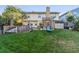 Expansive backyard with green lawn, wooden deck, and a privacy fence, perfect for outdoor enjoyment at 10961 Main Range Trl, Littleton, CO 80127