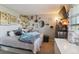 Eclectic bedroom with posters, TV, string lights, shelves with collectibles, and comfortable soft furnishings at 10961 Main Range Trl, Littleton, CO 80127