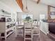 Open dining area with vaulted ceilings, modern chandelier, and breakfast bar seating at 10961 Main Range Trl, Littleton, CO 80127