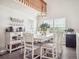 Bright dining area with vaulted ceilings and a view of the upstairs loft at 10961 Main Range Trl, Littleton, CO 80127