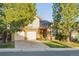 Charming two-story home with a brick facade, two-car garage, and well-maintained front lawn at 10961 Main Range Trl, Littleton, CO 80127