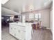 Open-concept kitchen with white cabinets and island, flows seamlessly into the dining and living spaces at 10961 Main Range Trl, Littleton, CO 80127