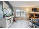 Stylish living room with gray accent wall, brick fireplace, and hardwood floors at 10961 Main Range Trl, Littleton, CO 80127