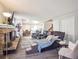 Spacious living room featuring a brick fireplace and open layout at 10961 Main Range Trl, Littleton, CO 80127
