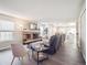 Open living room with a fireplace and seamless flow to the kitchen and dining area at 10961 Main Range Trl, Littleton, CO 80127