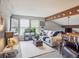 Inviting living room featuring a neutral couch, bright windows, wood accents and a cozy atmosphere at 10961 Main Range Trl, Littleton, CO 80127