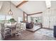 Open-concept living space combines dining and living areas, with vaulted ceilings and cozy fireplace at 10961 Main Range Trl, Littleton, CO 80127