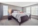 Serene main bedroom with a large bed, soft bedding, and natural light from windows with bright shutters at 10961 Main Range Trl, Littleton, CO 80127
