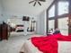 Spacious primary bedroom featuring high ceilings, a sitting area, and mirrored closet doors at 10961 Main Range Trl, Littleton, CO 80127