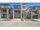 Modern townhome with stone accents, a covered balcony, and an attached garage, showcasing its contemporary design at 3147 S Russell St, Morrison, CO 80465