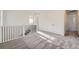 Bright hallway featuring neutral carpet, staircase with black metal spindles, and white trim at 3147 S Russell St, Morrison, CO 80465