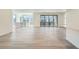 Open-concept living area featuring hardwood floors, neutral walls, and sliding glass doors to the balcony at 3147 S Russell St, Morrison, CO 80465