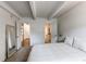 A cozy bedroom boasts two entryways with a closet and a door leading to the bathroom at 1265 Race St # 408, Denver, CO 80206