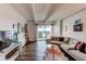 Comfortable living room with a large sectional sofa, balcony access, and stylish decor at 1265 Race St # 408, Denver, CO 80206