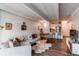 Living room with couch, wood floors, and bar top with kitchen access at 1265 Race St # 408, Denver, CO 80206