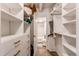 Well-organized walk-in closet offering customized storage solutions and easy access to en suite bathroom at 1265 Race St # 408, Denver, CO 80206