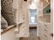 Spacious walk-in closet with custom shelving and drawers, leading to the bedroom at 1265 Race St # 408, Denver, CO 80206