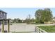 Backyard view with a white fence, green grass, decorative rock garden, and trees adding a touch of nature at 6711 Fraser Cir, Frederick, CO 80530