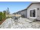 Backyard with flagstone patio, dining table, swing set, and lush greenery, creating a Gathering-friendly outdoor space at 6711 Fraser Cir, Frederick, CO 80530