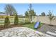 Backyard featuring a swing set, slide, and flagstone patio for play, with a border of rocks and shrubbery at 6711 Fraser Cir, Frederick, CO 80530