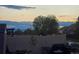 Fenced backyard featuring a grill and patio furniture, ideal for outdoor entertaining and relaxation at twilight at 6711 Fraser Cir, Frederick, CO 80530