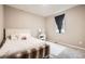 Bright bedroom with a white bed, matching vanity, and a large window, offering a serene and minimalist space at 6711 Fraser Cir, Frederick, CO 80530
